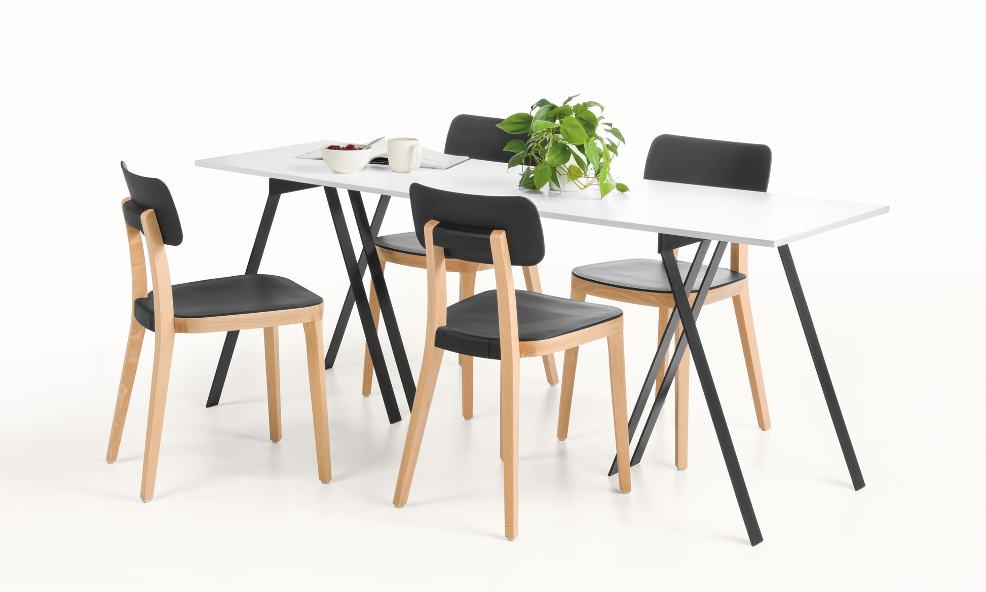 Dining table set with four chairs on a white background
