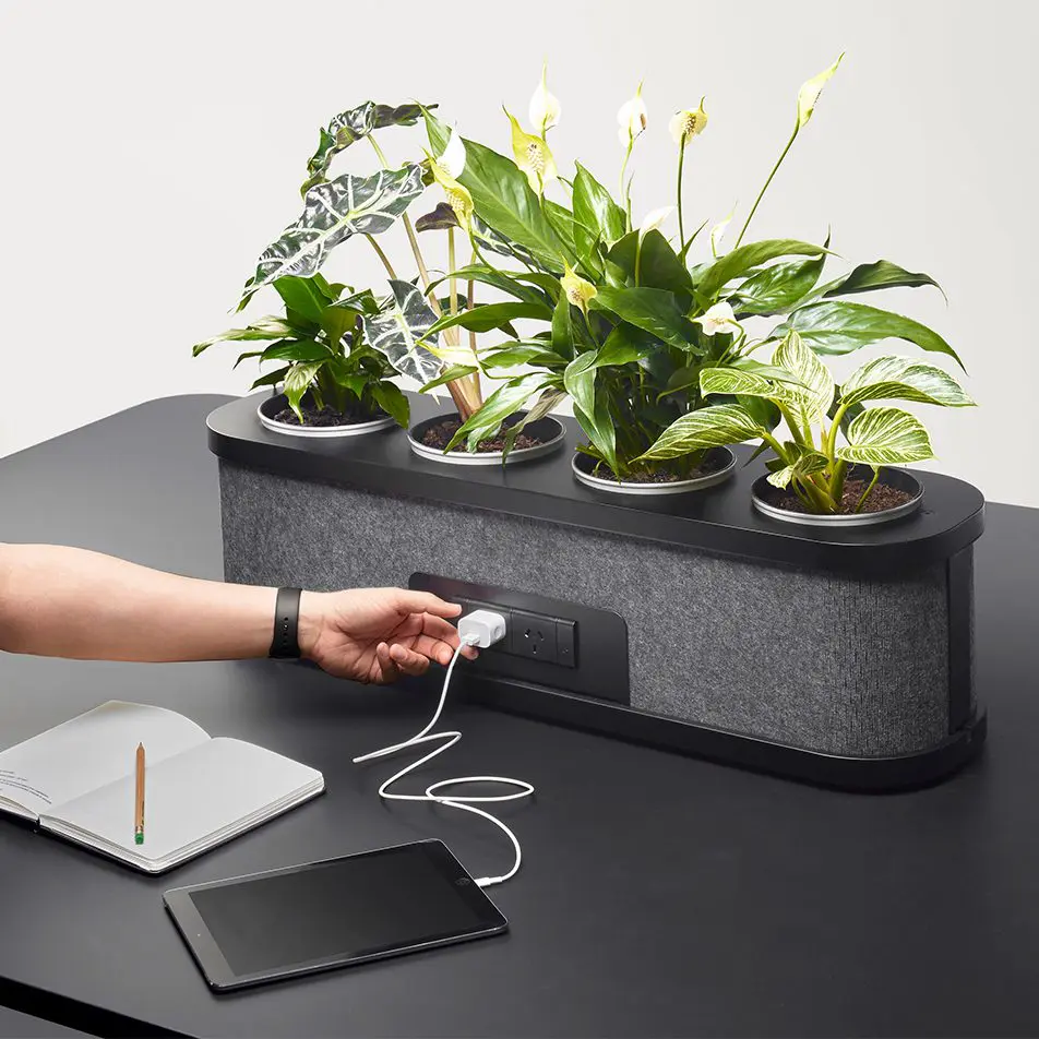 A Rosie Table with optional Planter that contains power outlets.