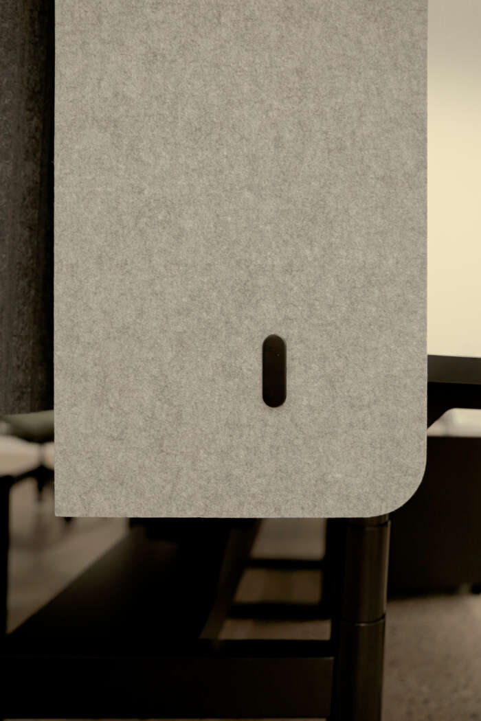 Edge of Booth Acoustic Desk Panel positioned on a desk.